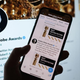 A hand (maybe a celebrity’s hand!?) scrolls through the Golden Globes’ Twitter feed.